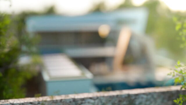 Blurry teaser thumbnail of Ivy's yoga session outdoors by pool