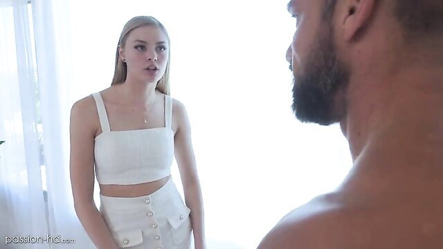 Sensual blonde Amber Moore in tight white top and skirt teasing man
