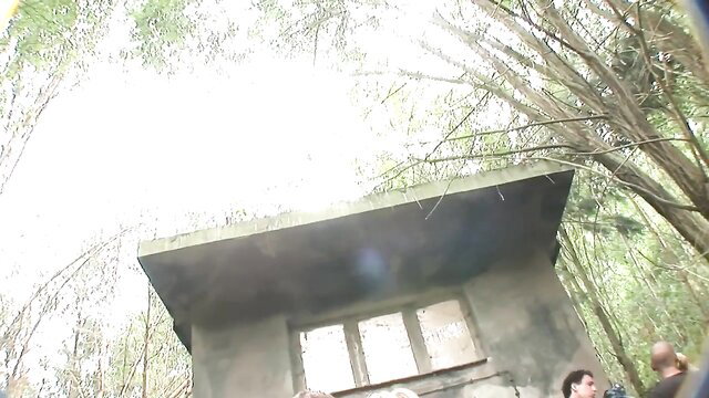 German piss orgy in forest: concrete bunker with group of people