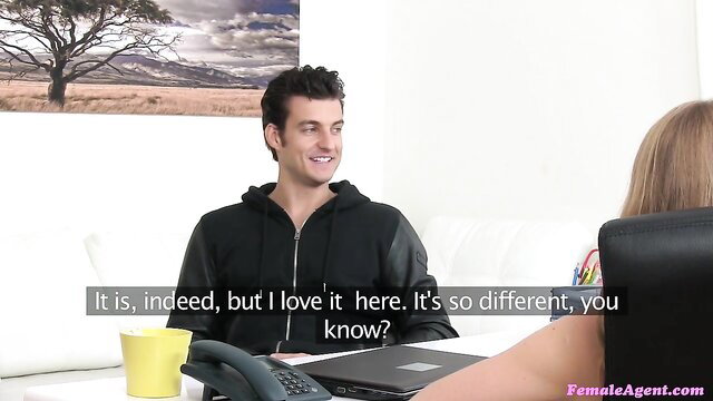 Handsome guy in hoodie chats with elegant blonde agent in office casting