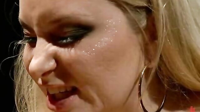 Blonde imperious mistress with glitter makeup in slave training