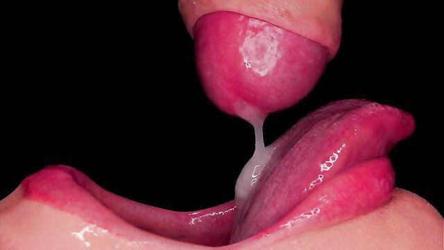 Close-up of passionate oral sex with cum dripping on tongue and in mouth