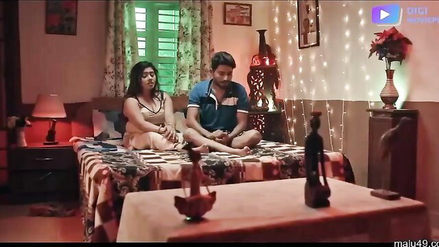 Indian bhabhi in bra and shorts sits with devar on bed in hot scene