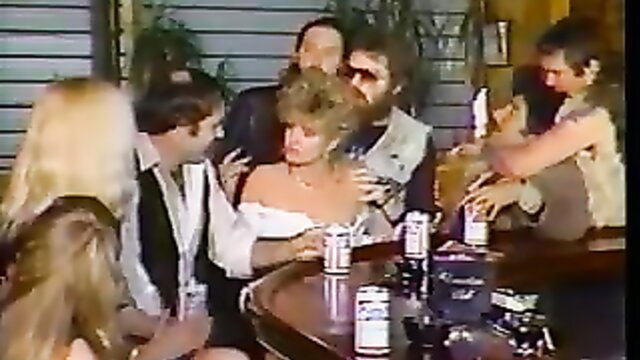Vintage blonde in off-shoulder dress surrounded by bikers at bar gangbang