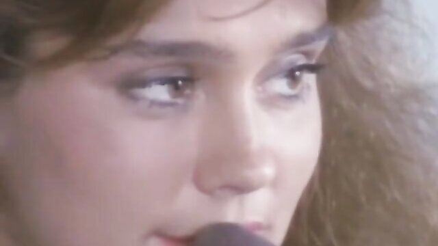 Jeanna Fine closeup eyes lips mic Peter North porn thumbnail