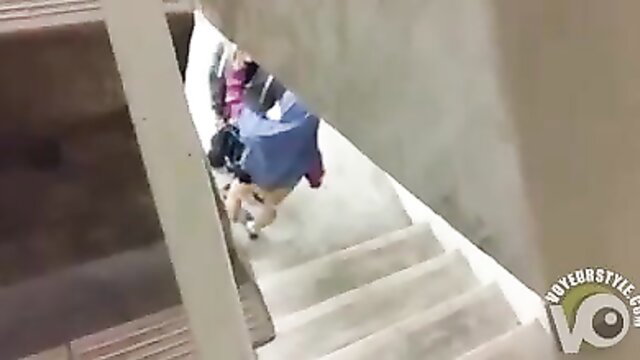 Muslim couple in hijab having fun under stairs amateur style