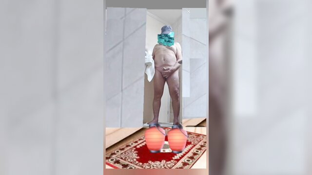 Nude mature Asian man in mask standing solo with towel and red orbs
