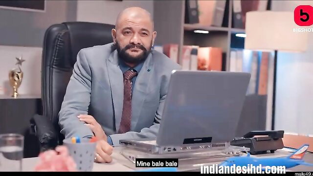 Bald Indian man in suit at desk in Dakhila Episode 4 adult web series thumbnail