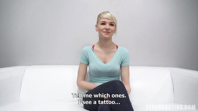 Blonde amateur with undercut shows tattoos in tight top, sexy smile