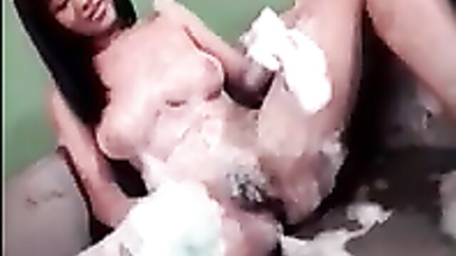 Asian babe covered in thick white cum, smiling and spreading legs wide