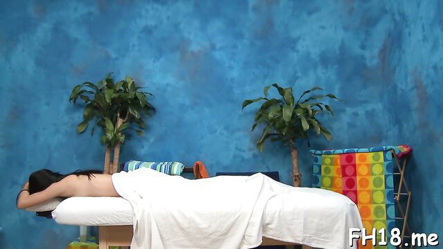 Nude Alaina Kristar lying face down on massage table