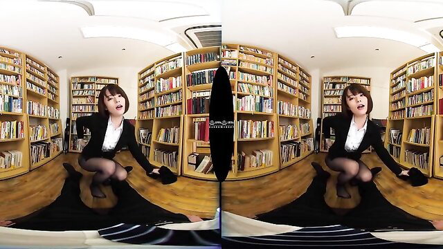 Asian office vixen in suit skirt squats seductively in library