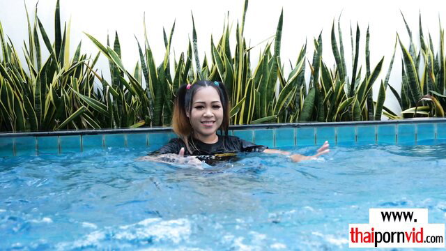 Amateur Thai teen Tuk in pool with pigtails, wet tee shirt tease