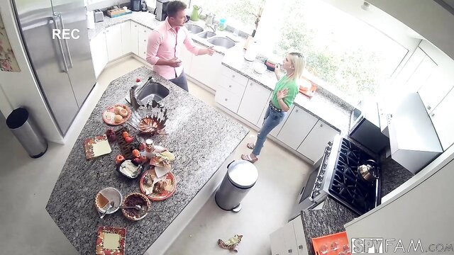 Hot blonde stepsis in green top bent over kitchen island on Thanksgiving