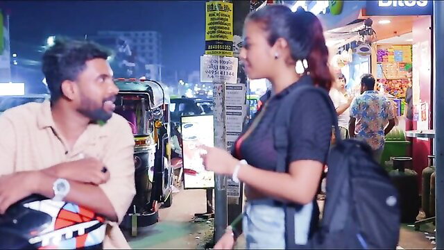 Horny Indian MILF in tight top and shorts chats with guy on busy night street