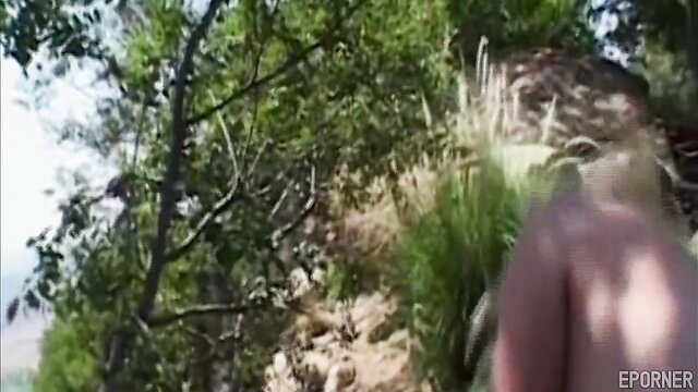 Blonde babe nude hiking outdoors in lush green hills