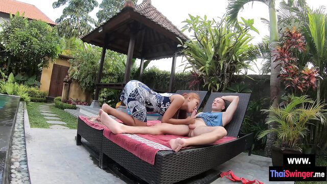 Asian teen in dress rides big cock outdoors poolside