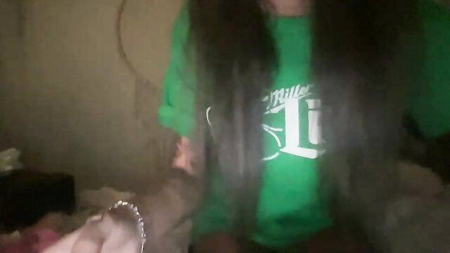 Fifiluv in green Miller Lite hoodie, long dark hair, teasing pose