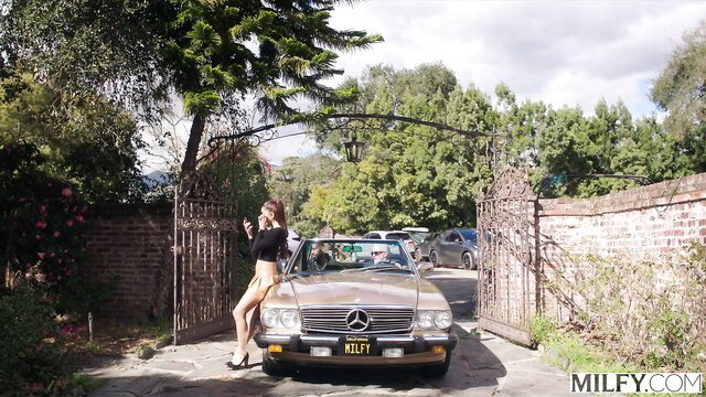 Hot MILF Melissa in mini skirt poses sexy by vintage Mercedes