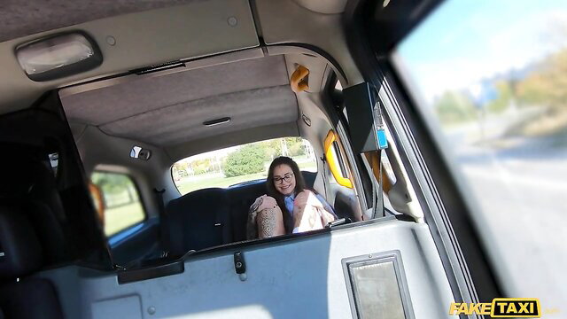 Mari Galore in glasses smiling in Fake Taxi van, tattooed brunette ready for hardcore