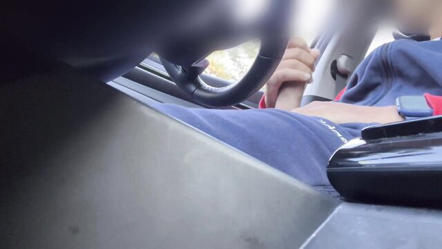 POV of slim Asian guy cruising in truck, hand on wheel, casual drive