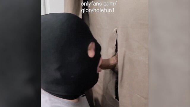 Masked man deepthroats thick Latino cock through gloryhole