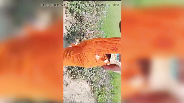 Hot Indian Bhabhi in orange saree flashes tits outdoors on webcam