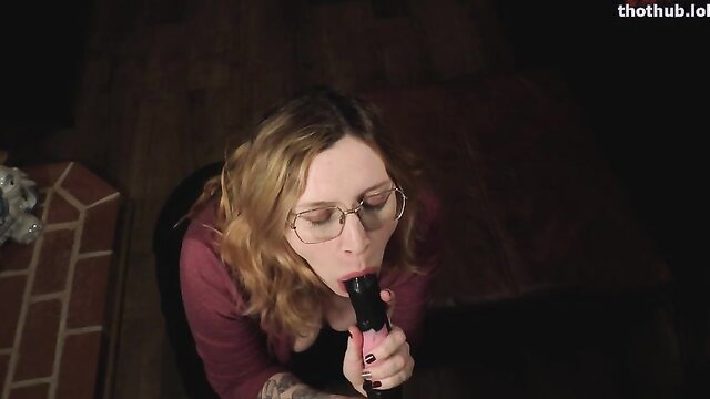 Bettie Bondage blonde in glasses sucking pink dildo closeup