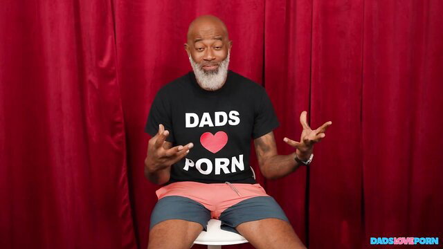 Bald black daddy Shaundam in Dads Love Porn tee poses for BangBros
