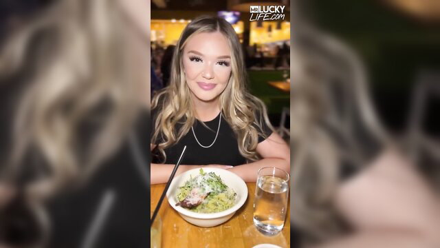 Holly Day smiling at restaurant table with blonde hair and black top