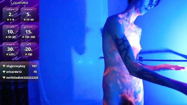 Aurora Sheridan nude in steamy shower, tattoos glowing blue
