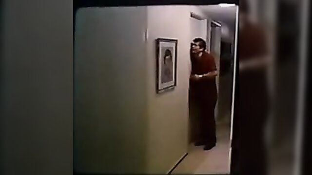 Man peeking at framed nude photo in 1976 classic Paul Lisa Caroline