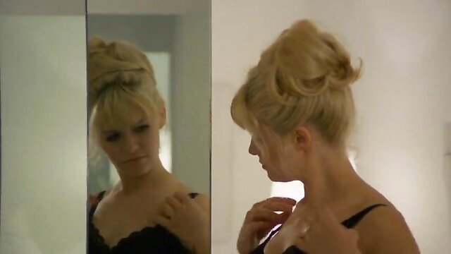Blonde bombshell in black lace bra, retro updo, mirror nude tits tease