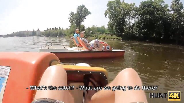 Blonde amateur couple on boat, playful teasing in wild outdoor adventure