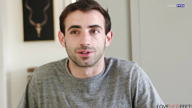 Alex Coal smiling in gray sweater, LoveHerFeet foot fetish thumbnail