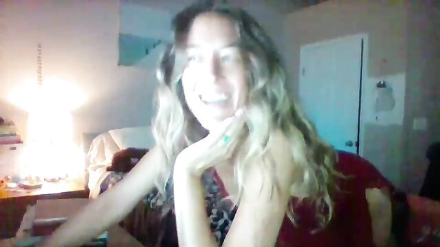 Scarlett1126 smiling camgirl topless in red top, blonde hair blue eyes