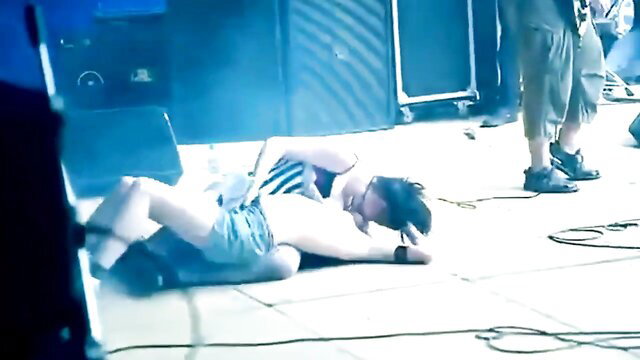 Slim Asian guy passed out on stage in tight shorts, public degeneracy exposure