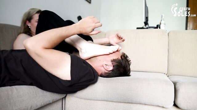 Blonde sister's smelly bare feet on man's face, foot worship closeup