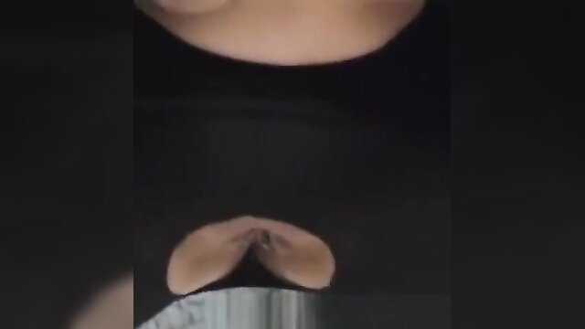 Buxom mummy's huge tits exposed in low-cut black top, closeup