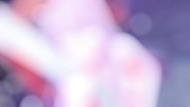 Blurry purple-lit adult video thumbnail with pink skin tones and glowing highlights