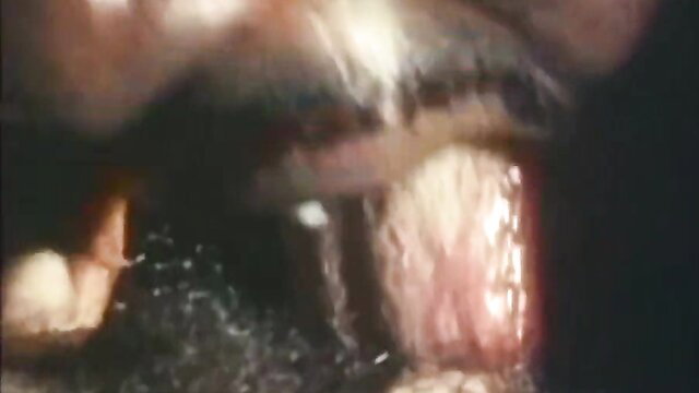 Extreme closeup of gaping mouth with teeth and saliva in fetish vid