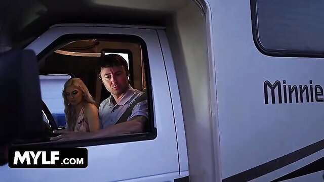 Kenzie Taylor and Gal Ritchie in car with RV on road adventure