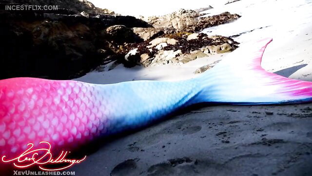 Naughty pink mermaid tail on beach, sexy fantasy tease