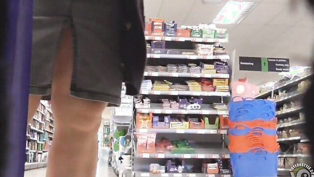 Fat woman in revealing miniskirt upskirt view in supermarket