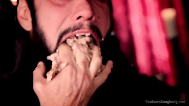 Man with beard devours flesh in satanic virgin sacrifice ritual