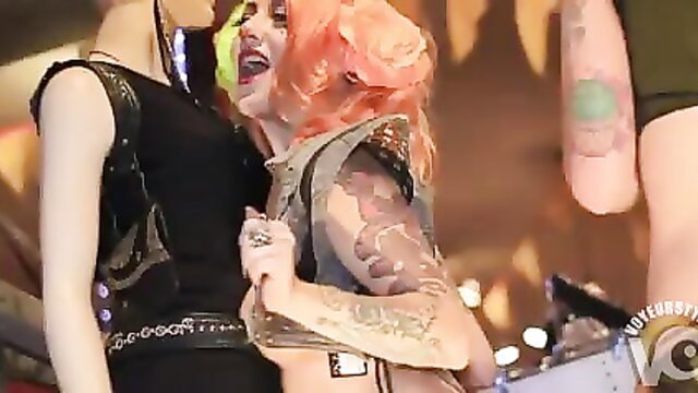 Three tattooed strippers with orange hair flaunt inked bodies on stage