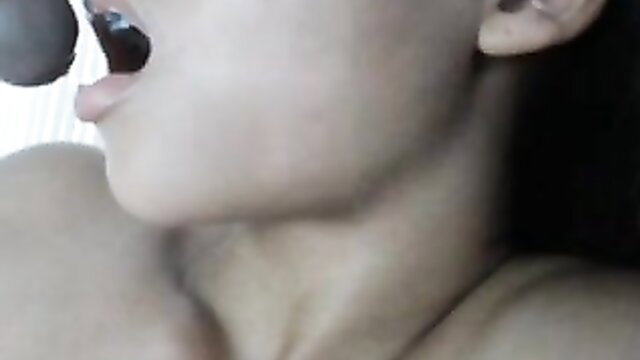 Asian babe lips on black dildo, shaved pussy tease closeup