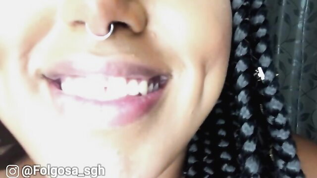 Smiling black woman with nose ring and braids, hot JOI mouth tease