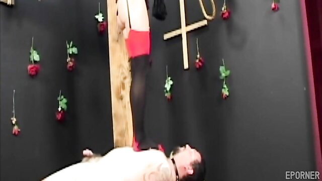 Raunchy FEMDOM mistress in red lingerie stands on bound sub's face