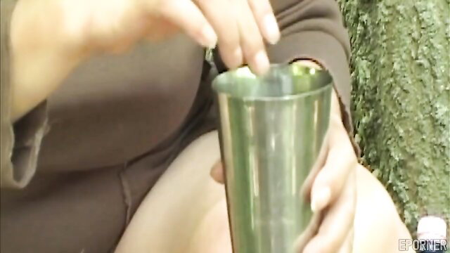 Hairy granny Sharone Lane pinching clit outdoors in metal cup